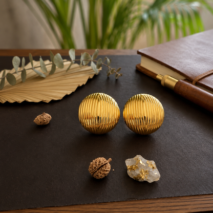 Flaire Studio ribbed gold ball stud earrings worn on model